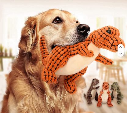 Hund leker med dinosaurieleksak i majsfiber – orange